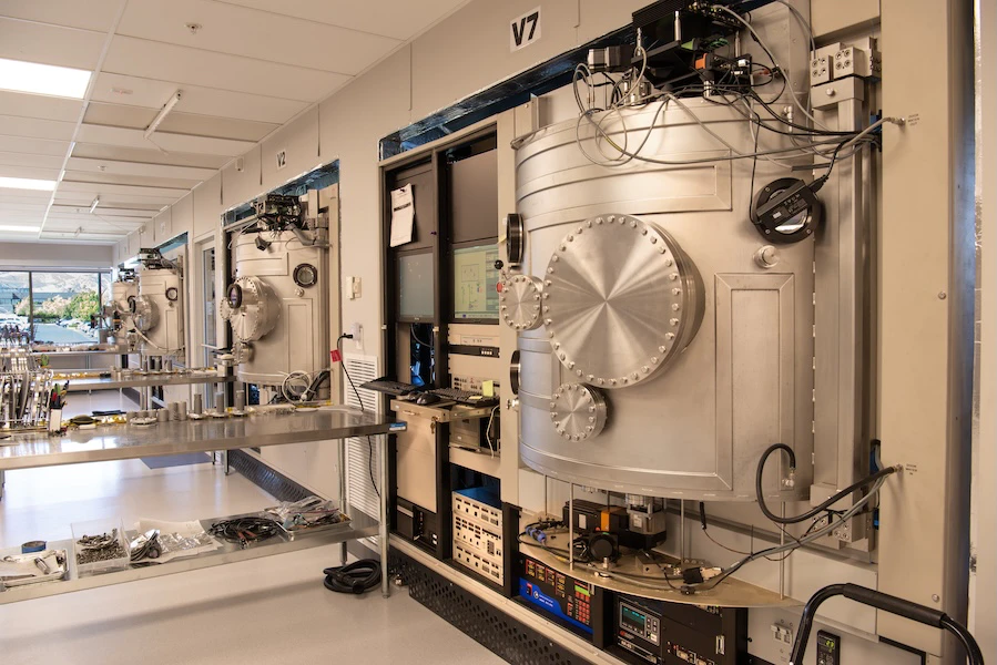 Laboratory workspace showing optical coating equipment